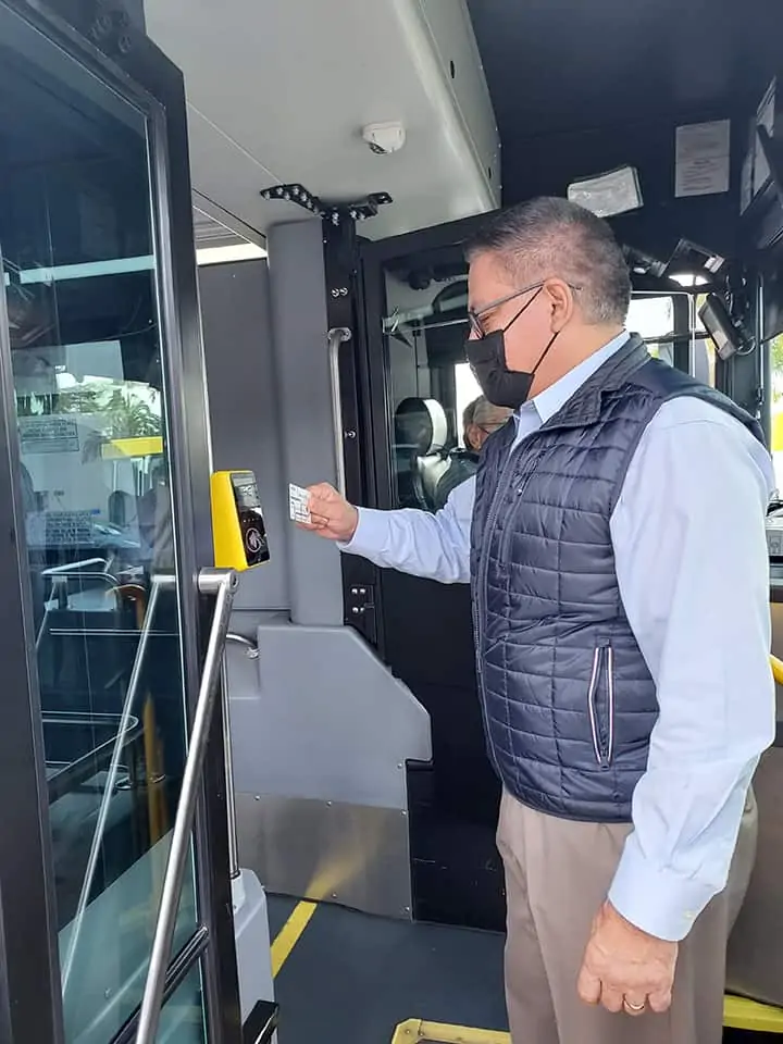 Congressman Carbajal pays for his bus trip by tapping a debit card on the card reader as he boards the bus.