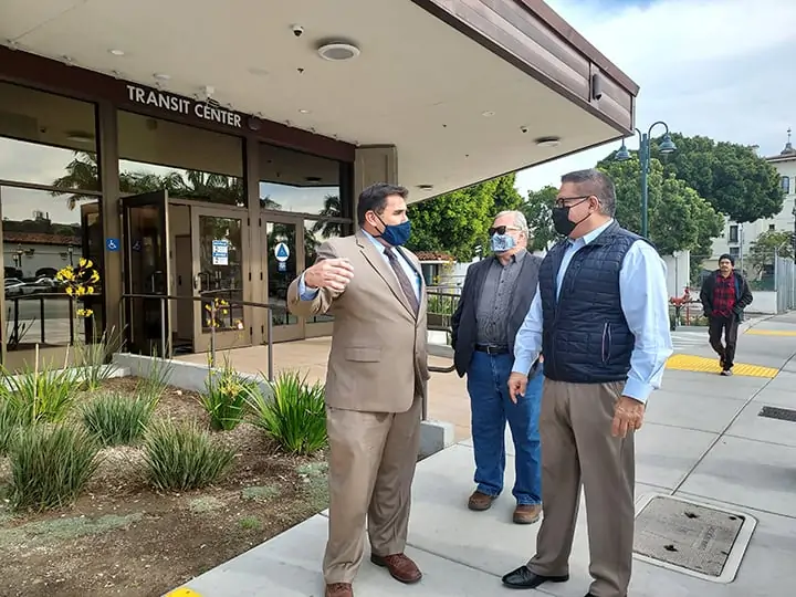 MTD GM Jerry Estrada, MTD Board Chair Dave Davis, and Congressman Salud Carbajal stand in front of the Transit Center. They are all wearing masks.