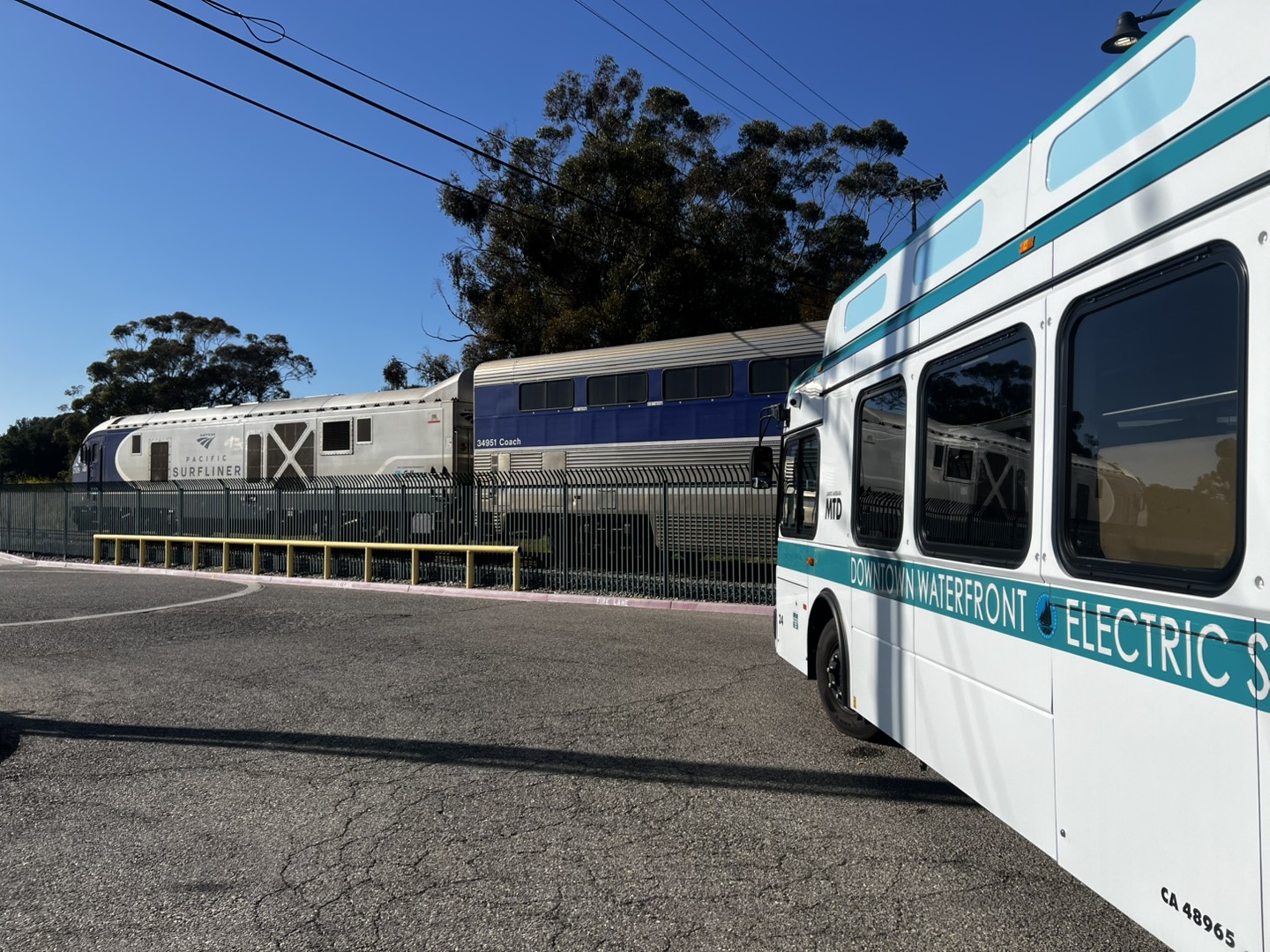 A photo of a First Mile Last Mile shuttle waiting for the Pacific Surfliner at the Amtrak station